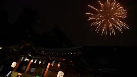 Getty Images Fireworks explode over the Okunitama shinto shrine in Fuchu in the western suburbs of Tokyo