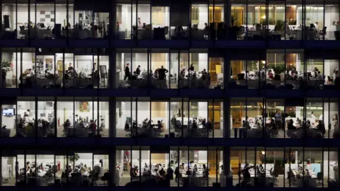 Getty Images Office workers at night