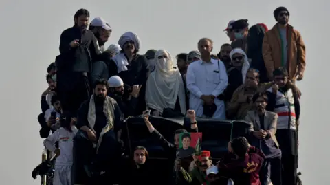 Reuters Bushra Bibi, wife of jailed Pakistani Prime Minister Imran Khan, and supporters of Khan's Pakistan Tehreek-e-Insaf (PTI) party attend a rally calling for his release, in Islamabad, Pakistan, November 26, 2024.