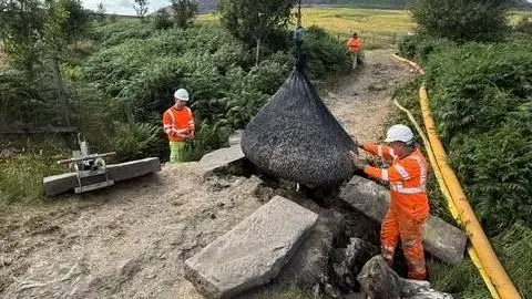 Derbyshire Fire and Rescue Service Workers carrying out temporary repairs to a bridge near Crowden in the Peak District in Derbyshire