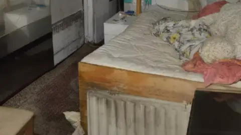 Met Police Police photos showing a heavily-stained bed inside the shipping container