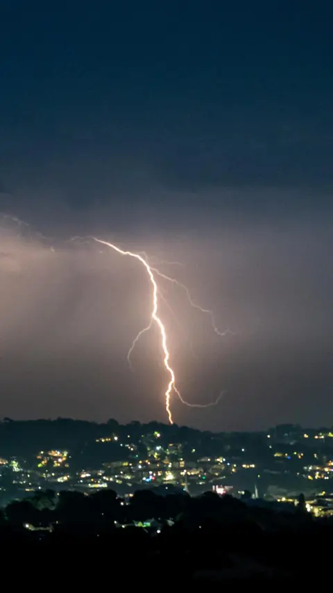 A lightning strike in Torquay. It is cloudy and grey.