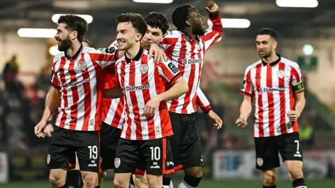 Darragh Markey of Derry City celebrates with Brandon Fleming, left. after scoring their side's second goal during the SSE Airtricity Men's Premier Division match between Derry City and Drogheda United at The Ryan McBride Brandywell Stadium in Derry.