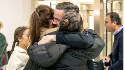 Brian Glendinning hugging family