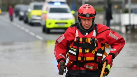 Ben Birchall/ PA Wire Mountain rescue workers have been working to save people from their homes