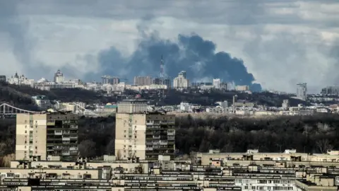 Getty Images Smoke rises over the part of Ukraine's capital situated on the right bank of the Dnipro River in the morning on Sunday, Kyiv, capital of Ukraine.