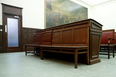 Reuters View of defendant's bench in a courtroom ahead of the trial of Salah Abdeslam, one of the suspects in the 2015 Islamic State attacks in Paris, at Brussels Palace of Justice, Belgium, 30 January