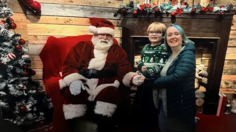 Helen Clarke Milo and Helen visiting Santa