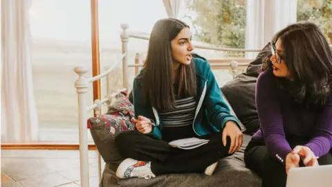 Getty Images Posed picture of parent and teenage daughter