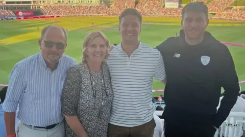 Brain Tumour Research/Handout Mr Walklin (left) with his mum Ms Walklin and family members