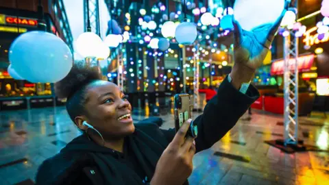 Highcross Leicester Woman holding light