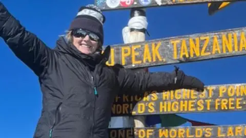 Gill Milane at peak of Mount Kilimanjaro