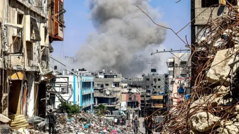 AFP Smoke rises following an Israeli strike in Jabalia, in the northern Gaza Strip (14 April 2024)