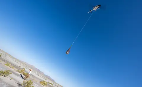 NASA/Keegan Barber The capsule is lifted clear of the desert floor