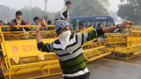 AFP Indian protestor hurling rock during demonstration