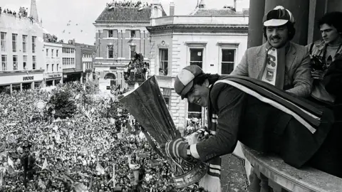 Archant Paul Mariner holds the Uefa Cup on the balcony of Ipswich Town Hall