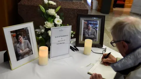 Reuters A man signs a book of condolence for Lyra McKee in the Guildhall in Londonderry