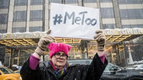 Getty Images Woman in New York holds aloft a MeToo placard