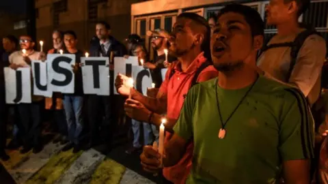 AFP/Getty Images Protesters outside the Sebin intelligence agency headquarters in Caracas, Venezuela. Photo: 8 October 2018