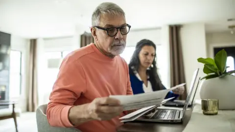 Getty Images a person looking at bills