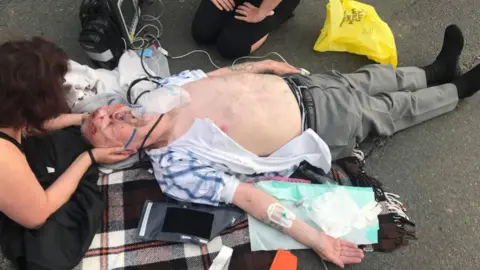 Family photo Man receiving treatment on road