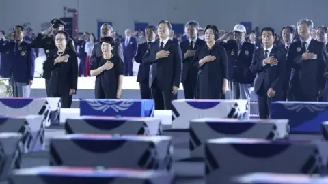 Yonhap South Korean President Moon Jae-in salutes to caskets containing remains of South Korean soldiers killed during the Korean War during a ceremony commemorating the 70th anniversary of the Korean War at Seoul Air Base in Seongnam, South Korea, June 25, 2020