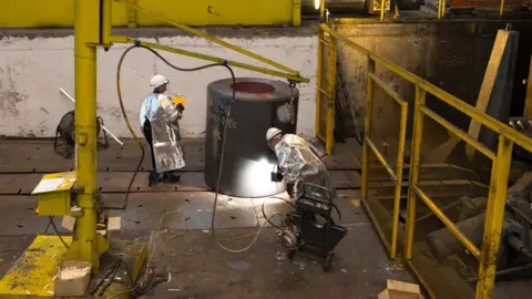 Workers looking at a roll of steel in Liberty Steel Newport