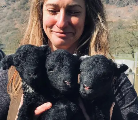 Jenny McGrath Jo holding three lambs