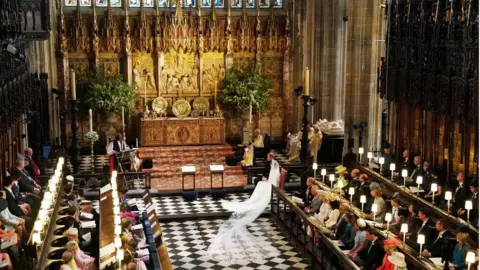 Reuters  Prince Harry and Meghan Markle listen to an address by the Most Rev Bishop Michael Curry, primate of the Episcopal Church, in St George's Chapel at Windsor Castle during their wedding service in Windsor, Britain, May 19, 2018