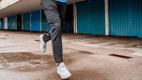 ti-ja/Getty Images Man wearing grey jogging bottoms