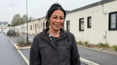 Kate Hollinshead from the Vale of Glamorgan Council stands in the street near the new temporary homes. 