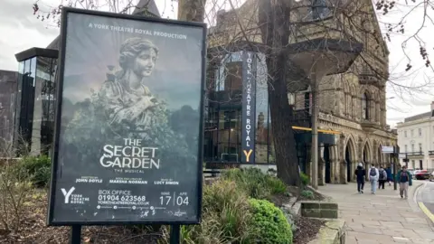BBC/Seb Cheer A poster advertising The Secret Garden - The Musical is displayed outside the York Theatre Royal.