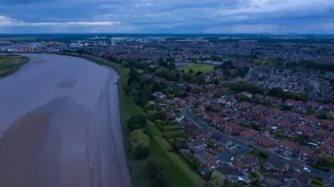 Getty Images A bird's eye view of the River Ouse and Goole town, featuring groups of houses, to the right. 