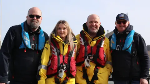 Eastbourne volunteer family crew members Ellie and Dan Guy with Dan's brother Tim (left) and dad Dick Guy (right).