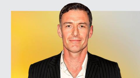 Chris Sutton smiles at the camera