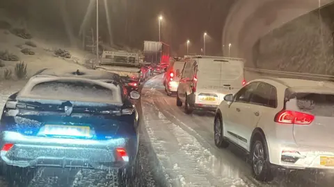 BBC Weatherwatchers/wiggy Cars in traffic jam in blizzard conditions on the A465 heads of the valleys road near Ebbw Vale