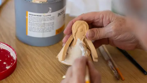 Hospice in the Weald A person crafting a ceramic angel. 