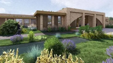 Brick crematorium building showing entrance into ceremony rooms and lawn and shrubs area in foreground