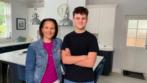 Max and his mum standing in the kitchen