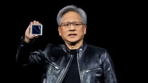 Getty Images Jensen Huang, co-founder and chief executive officer of Nvidia Corp., displays the new Blackwell GPU chip during the Nvidia GPU Technology Conference (GTC) in San Jose, California, US, on Monday, March 18, 2024. 