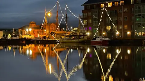 Tony Christmas lights reflecting on Gloucester Docks.