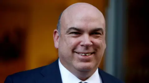 Reuters Mike Lynch smiles as he leaves the High Court in London