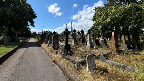 BBC A general view of Rock Cemetery in Nottingham showing gravestones on the right of the frame, taken from a footpath alongside.