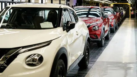 Reuters A row of new white and red electric Nissan cars at its factory in Sunderland