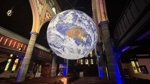 BBC Gaia globe suspended from the ceiling in St Thomas' Church