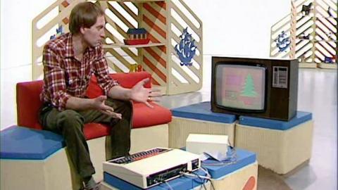 Simon Groom its on the Blue Peter sofa, beside a computer with a Christmas card on it