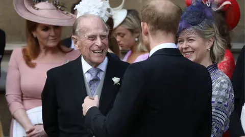 PA The Duke of Edinburgh laughs with his grandson, Prince Harry