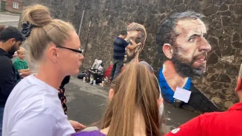 James Bennett Bystanders admire the work