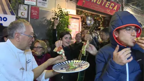 AFP Pizza-makers handed out free pizza to celebrate the listing
