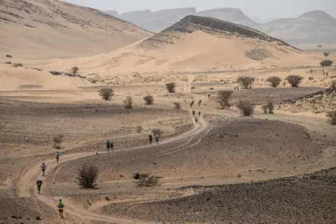Jean-Philippe Ksiazek / AFP Competitors take part in the first stage of the 37th edition of the Marathon des Sables